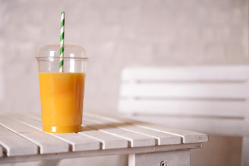 Orange juice in fast food closed cup with tube