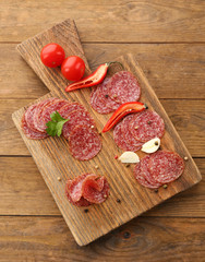 Slices of salami with spices and vegetables