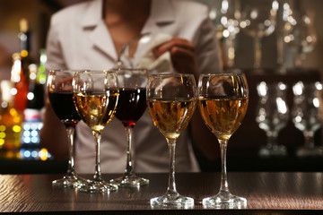 Bartender working at counter on bar background