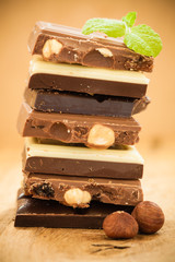 Stack of different sorts chocolate and hazelnuts
