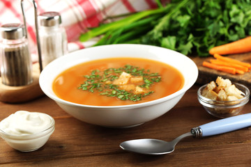 Composition with carrot soup, ingredients and herbs