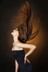 Beautiful dancing young woman with flowing long hair