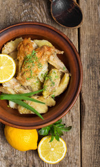 roasted chicken on a plate on a wooden background