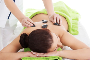 Obraz na płótnie Canvas Girl on a stone therapy, hot stone massage