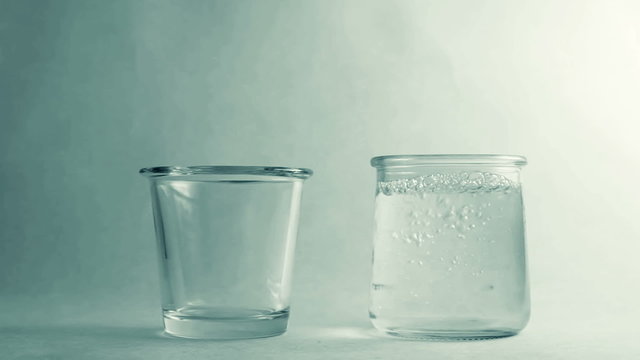 Filling two different glasses of water. 50 / 50
