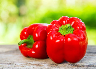 Fresh red pepper on wooden table on nature background