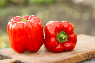 Fresh red pepper on wooden table on nature background