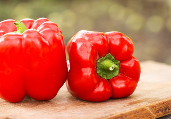 Fresh red pepper on wooden table on nature background