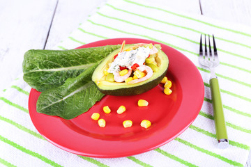 Tasty salad in avocado on plate table close-up