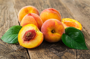 Naklejka na ściany i meble group of fresh peaches on wood background