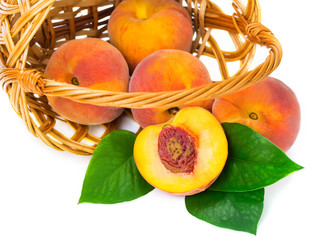 Fresh peaches in a basket on a white background