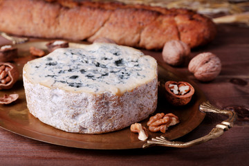 Blue cheese with nuts, baguette and hay