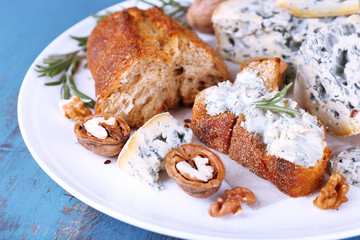 Blue cheese with sprigs of rosemary, bread and nuts