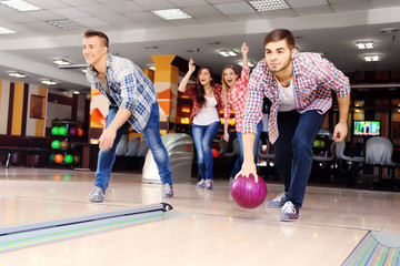 Friends playing in bowling club