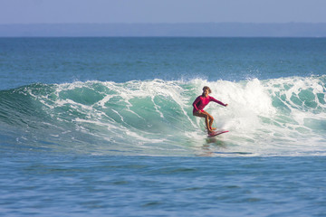 Surfer girl on the wave, Indonesia.