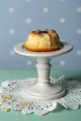 Delicious cheesecake on table, on color background