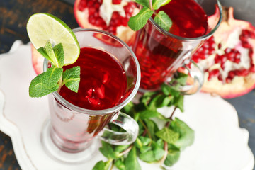 Pomegranate drink in glasses with mint and slices of lime