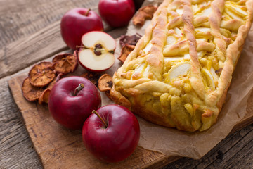 Naklejka na ściany i meble Apple pie on a board with fresh apples