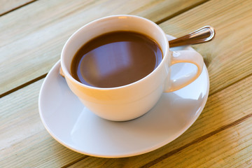 milky coffee cup on wooden table