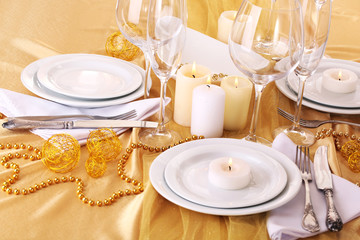 Beautiful holiday table setting in white and gold color