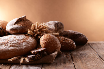 Different bread on table on brown background