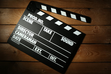 Movie clapper on wooden background