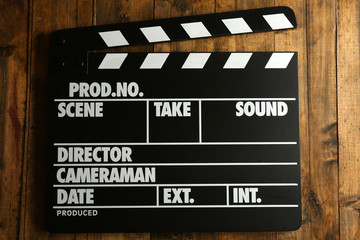 Movie clapper on wooden background