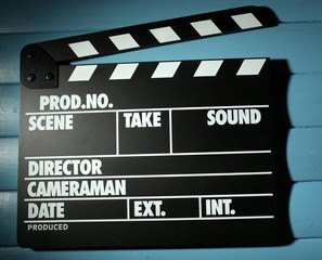 Movie clapper on wooden background