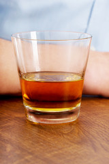 Yound man in depression, drinking alcohol