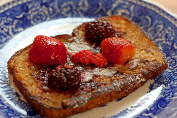 French toast and red fruits served on a  talavera dish