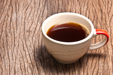 A cup of coffee on wood background