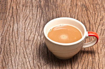 A cup of coffee on wood background