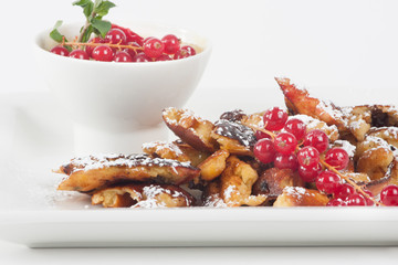 cut-up and sugared pancake with raisins