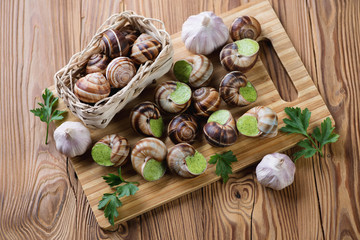 Escargots de Bourgogne, fresh parsley and garlic bulbs