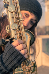 Fototapeta premium Beautiful young woman with her saxophone