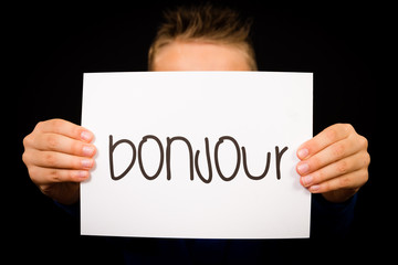 Child holding sign with French word Bonjour - Hello © Mikkel Bigandt