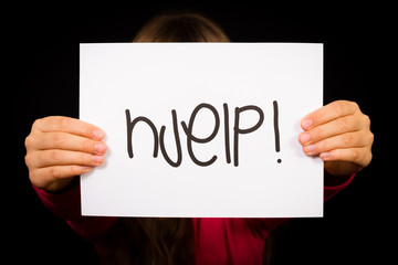 Child holding sign with Norwegian word Hjelp - Help