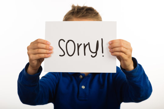 Child Holding Sorry Sign