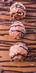 Chocolate balls toppings on chocolate cheese cake close up view