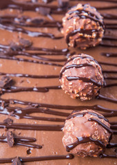 Chocolate balls toppings on chocolate cheese cake close up view