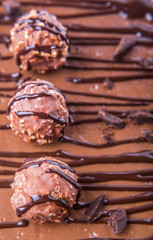 Chocolate balls toppings on chocolate cheese cake close up view