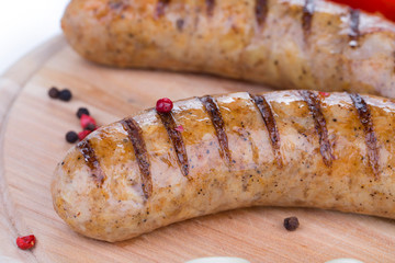 Close up of fried sausages on wood.