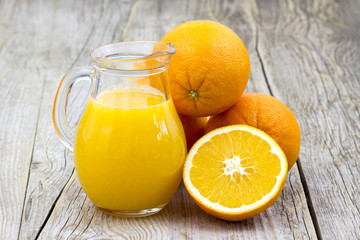 Naklejka na ściany i meble orange juice and fresh fruits on wooden background