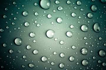 Drops of water on the colored background
