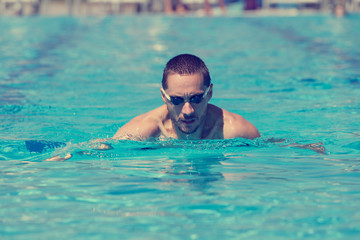 Slim sportsman swimming.
