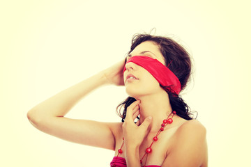 Beautiful brunette with red eyeband and necklace.