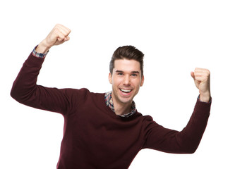 Happy young man cheering with arms raised