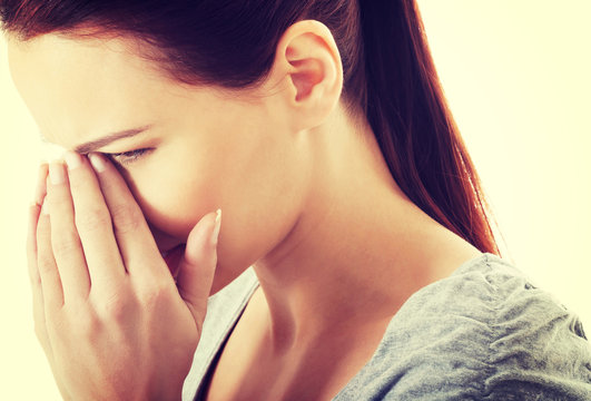 Beautiful woman touching her nose.