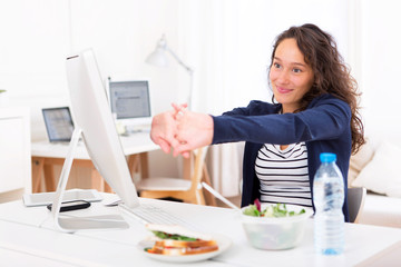 Young attractive woman stretching during a break