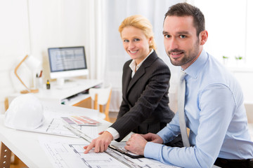 Young attractive engineer working at the office